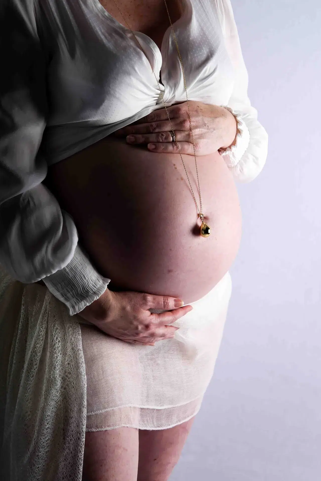 Bridge And Groom Standing While Holding Flower Bouquet